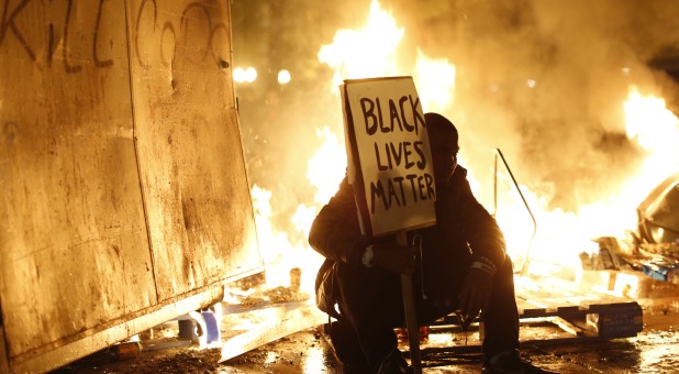 Ferguson Smolders After Racially Charged Riots Over Slain Teenager
