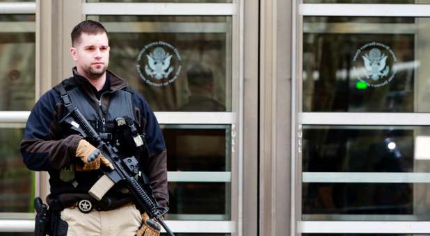 An armed U.S. Marshall stands outside federal court in Brooklyn before the court appearance of Tairod Nathan Webster Pugh.