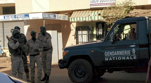 Mali security forces outside the Radisson Hotel while hostages are held inside.