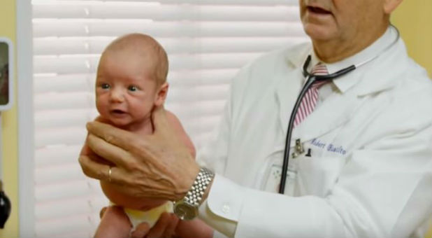 Robert Hamilton works to calm a crying baby.