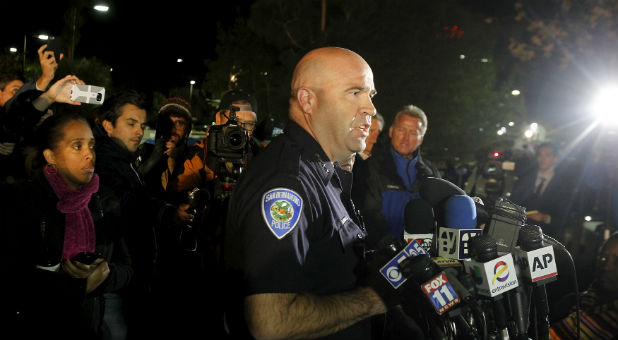 San Bernardino Police Chief Jarrod Burguan (center) speaks at a news conference, informing the media that the couple, Syed Rizwan Farook, 28, and Tashfeen Malik, 27, were responsible for the shooting rampage at the Inland Regional Center.