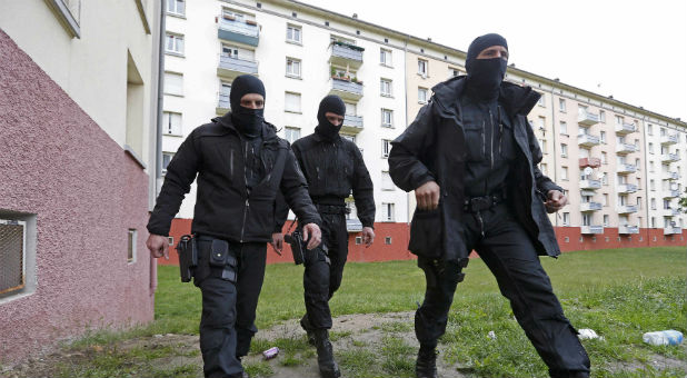 French police patrol a suburb.