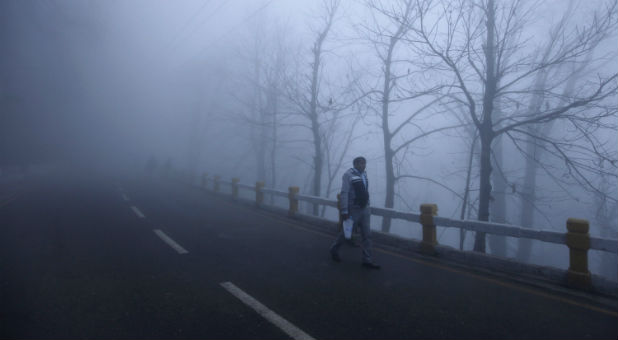 A man walks to work in Pakistan.