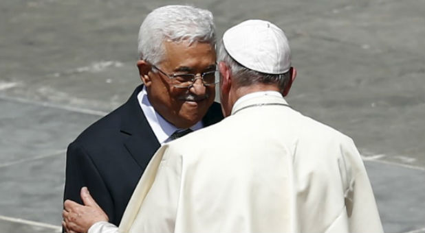 Pope Francis (R) embraces Palestinian President Mahmoud Abbas at the end of the ceremony for the canonisation of four nuns at Saint Peter's square.