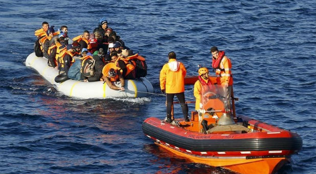 Members of the Turkish Coast Guard assist migrants.