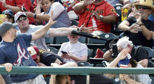 Shaun Cunningham saves his son from a flying bat.