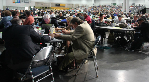 Delegates at the United Methodist Church General Conference in Portland, Ore., spent time in prayer on May 17, 2016 after Bishop Bruce Ough addressed rumors the denomination's Council of Bishops was considering a proposal to split the church