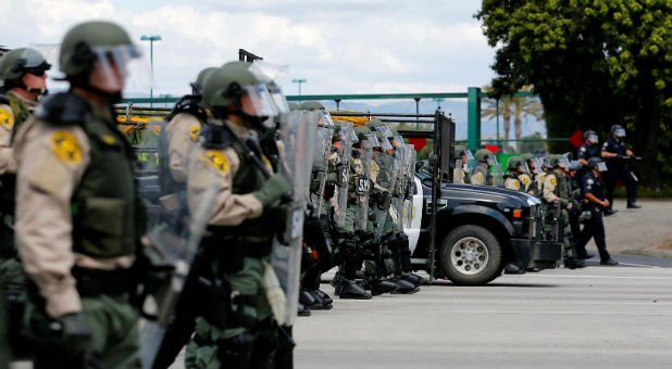 Police in riot gear clear a street of protesters near the convention center where U.S. Republican presidential candidate Trump was holding a campaign rally