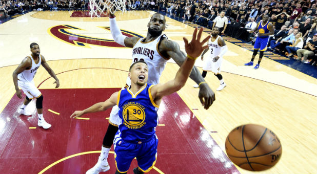 Cleveland Cavaliers forward LeBron James (23) blocks a shot by Golden State Warriors guard Stephen Curry (30) during the fourth quarter in game six of the NBA Finals at Quicken Loans Arena.