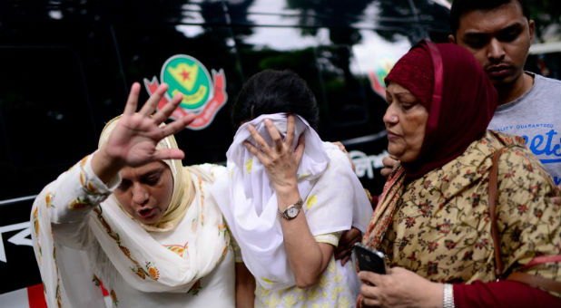 People grieve after Islamist attack on restaurant in Dhaka, Bangladesh.