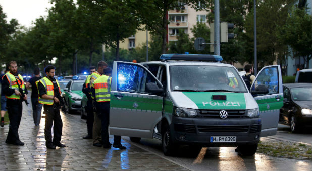 Police secure a street near to the scene of a shooting in Munich, Germany