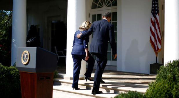 President Barack Obama and then Secretary of State Hillary Clinton walk back to the Oval Office after a statement following the death of the U.S. Ambassador to Libya, Chris Stevens, and others, in the Rose Garden of the White House in Washington