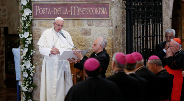 Pope Francis speaks outside the Porziuncola, the chapel inside the Saint Mary of Angels Basilica, in the pilgrimage town of Assisi, central Italy
