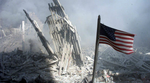 An American flag flies near the base of the destroyed World Trade Center after planes crashed into each of the two towers, causing them to collapse in New York, U.S. on Sept. 11, 2001.