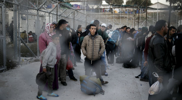 Refugees and migrants wait to be registered at the Moria refugee camp on the Greek island of Lesbos