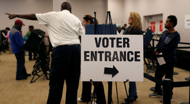 Voters wait in line to cast their ballots during early voting at the Franklin County Board of Elections in Columbus, in Columbus, Ohio