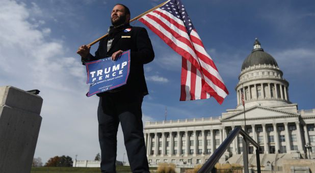 Donald Trump supporter Kern Carlos Huerta waits at the Utah State Capitol building for demonstrators protesting the election of Republican Donald Trump as president of the United States in Salt Lake City, Utah.