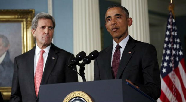 U.S. President Barack Obama delivers a statement after meeting with the National Security Council, accompanied by U.S. Secretary of State John Kerry (L).