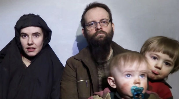 A still image from a video posted by the Taliban on social media on Dec. 19, 2016 shows American Caitlan Coleman (L) speaking next to her Canadian husband Joshua Boyle and their two sons.