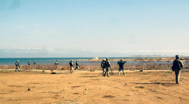 Guards patrol the Euphrates River.