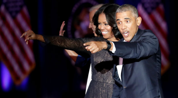 U.S. President Barack Obama and his wife Michelle acknowledge the crowd after President Obama delivered a farewell address