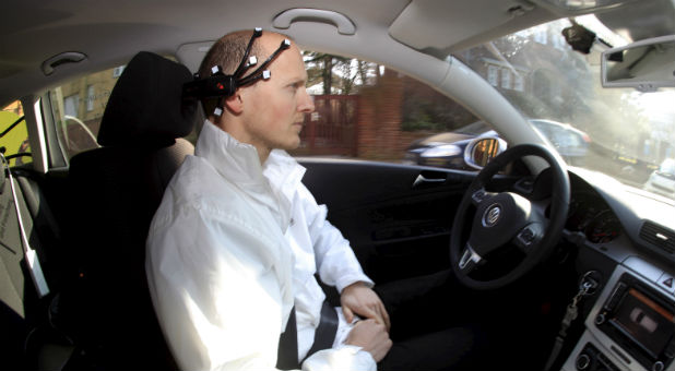Daniel Goehring, of the AutoNOMOS research team of the Artificial Intelligence Group at the Freie Universitaet (Free University), demonstrates hands-free driving of the research car named 'MadeInGermany' during a test in Berlin
