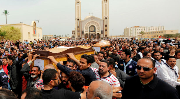 Relatives mourn the victims of the Palm Sunday bombings during the funeral at the Monastery of Saint Mina
