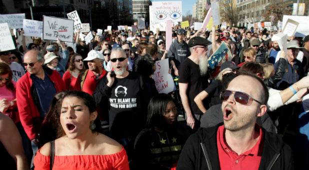 Anti-Trump protesters march towards the White House during the