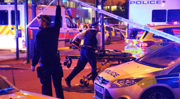 Police officers attend to the scene after a vehicle collided with pedestrians in the Finsbury Park neighborhood of North London.