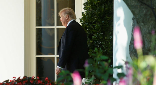 U.S. President Donald Trump walks out from the Oval Office of the White House in Washington.