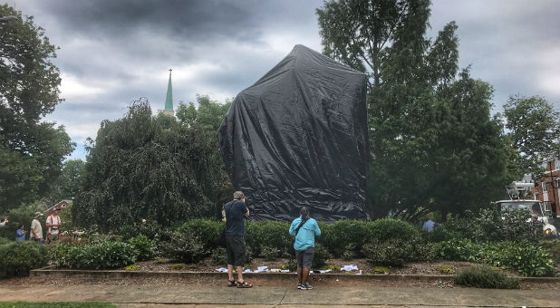 The statue of Confederate General Robert E. Lee is shown covered in black tarp in Charlottesville, Virginia.