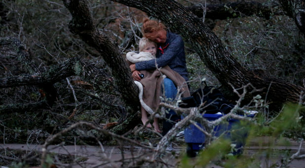 Lisa Rehr holds her 4-year old son Maximus, after they lost their home to Hurricane Harvey, as they await to be evacuated with their belongings from Rockport, Texas, Aug. 26, 2017.