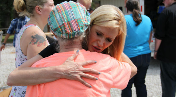 Paula White hugs a hurricane victim.