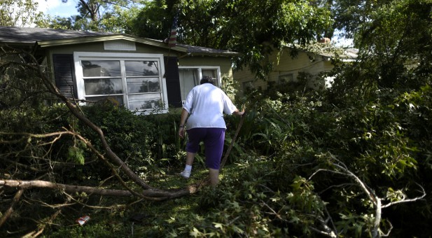 A woman evaluates her Jacksonville, Florida, home after Hurricane Irma.