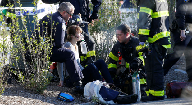 A woman is aided by first responders after sustaining injury on a bike path in lower Manhattan in New York.
