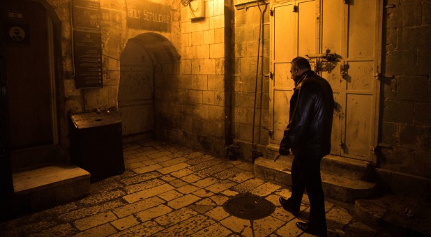 Adeeb Joudeh, a Muslim, walks as he holds the church key in Jerusalem's Old City.