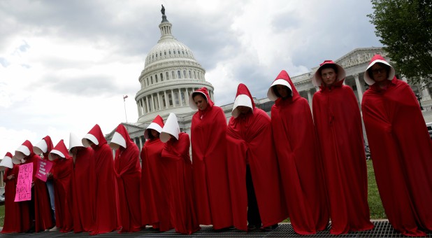 Women dressed as handmaids from the novel, film and television series