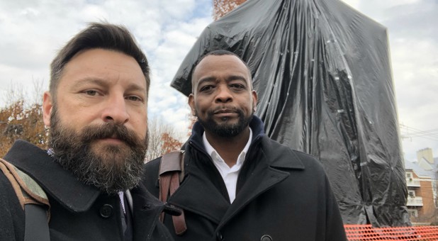 Matt Lockett and Will Ford in front of the covered Robert E. Lee statue.