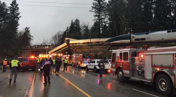First responders are seen at the scene of an Amtrak passenger train derailment on interstate highway (I-5).