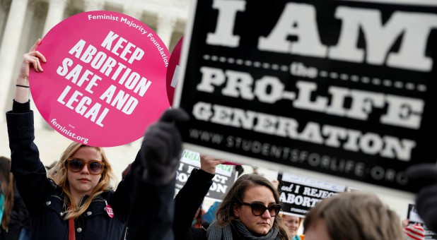 Pro-life and pro-choice activists gather at the Supreme Court for the National March for Life rally in Washington.