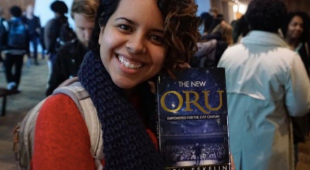 A student holds her copy of