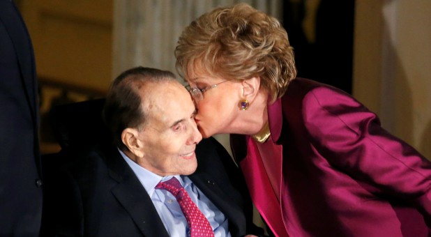 Former Senate majority leader Bob Dole (R-KS) receives a kiss from his wife Elizabeth Dole during a Congressional Gold Medal ceremony.