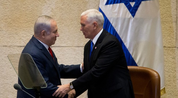 Israeli Prime Minister Benjamin Netanyahu shakes hands with U.S. Vice President Mike Pence.