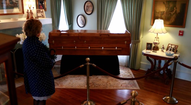 A woman pauses as she pays her respects to Billy Graham as he lies in a casket in his childhood home at the Billy Graham Library in Charlotte, North Carolina.