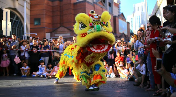 Performers dressed in costumes dance for spectators as part of celebrations for the Chinese Lunar New Year.