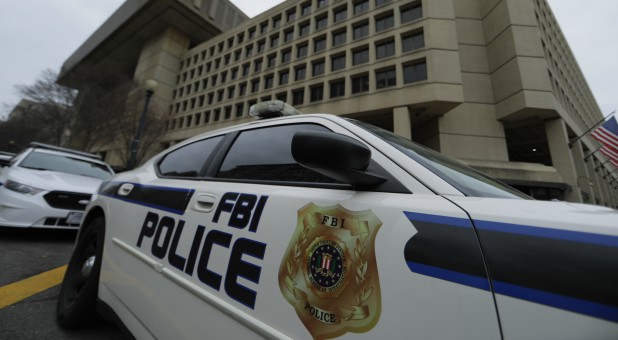 FBI Police vehicles sit parked outside of the J. Edgar Hoover Federal Bureau of Investigation Building in Washington.