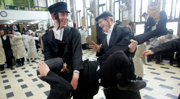 Ultra-Orthodox Jewish youths celebrate during an annual parade marking the Jewish holiday of Purim, in Jerusalem.