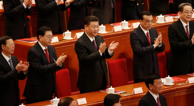 Chinese President Xi Jinping, Chinese Premier Li Keqiang and other top officials clap their hands during the closing session of the National People's Congress.
