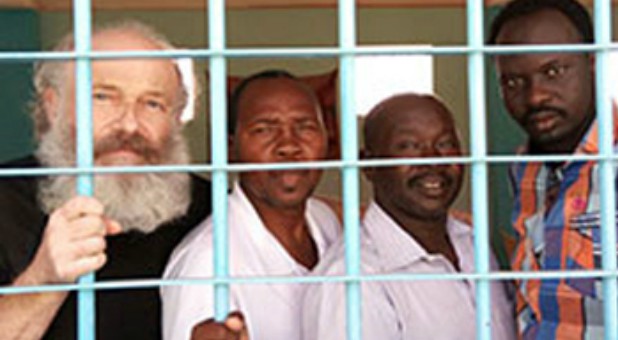 Petr behind bars with other Christian prisoners.