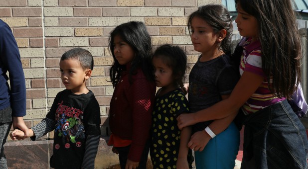 Children form a line as undocumented immigrant families are released from detention at a bus depot in McAllen, Texas.